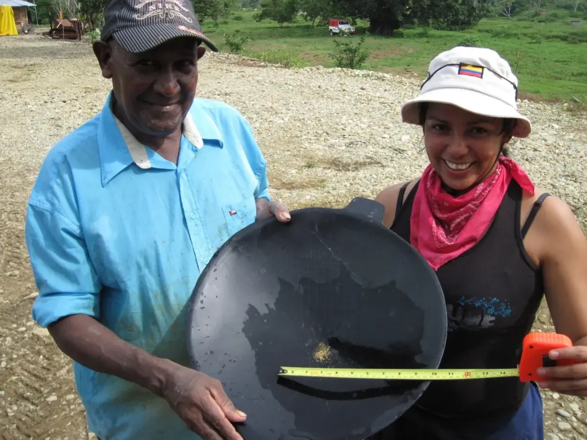 Two operators panning recovered gold concentrate.